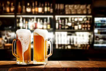 Glass of beer on wooden board and blurred bar background.Free space for your decoration.  - obrazy, fototapety, plakaty