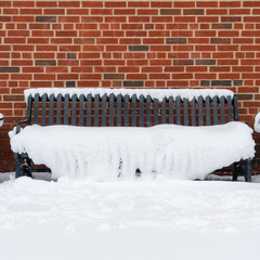 snow covered benches in park