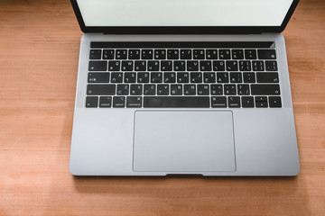 Conceptual workspace, Laptop computer with blank white screen on table, blurred background. use in...
