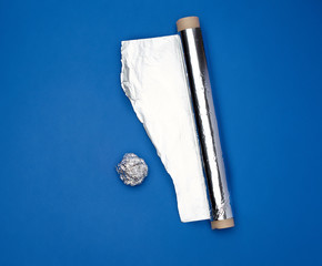 roll of gray foil for baking and packaging food on a dark blue background