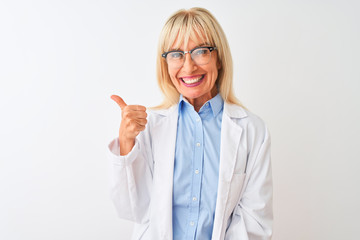 Middle age scientist woman wearing glasses standing over isolated white background doing happy thumbs up gesture with hand. Approving expression looking at the camera with showing success.