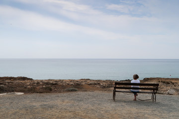 A woman contemplating the boundless distance of the sea