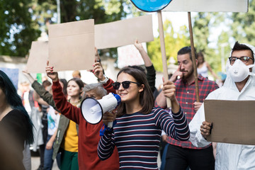 Obraz premium People with placards and amplifier on global strike for climate change.