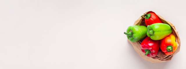 Top view of colored paprika in eco friendly paper bag