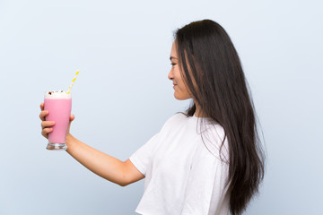 Teenager asian girl holding a strawberry milkshake with happy expression