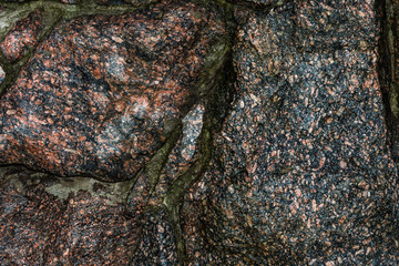 a wet wall of whole granite stones