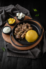 Hominy, corn porridge. Natural organic diet food. Tent with meat and cottage cheese. Restaurant menu. Background black boards.