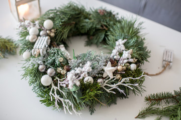 Beautifully decorated advent wreath with white decoration on a table