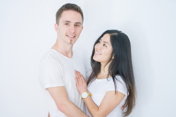 Fototapeta premium Young beautiful couple standing together over isolated white background