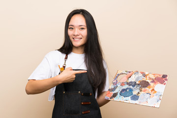 Teenager painter asian girl and pointing it