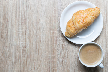 Coffee in white cup and croissants on wooden background, Breakfast concept
