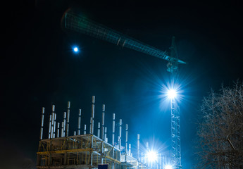 Construction of reinforced concrete multistory apartment building with crane in winter night, Yoshkar-Ola city, Mari El, Russia