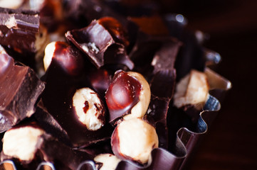 Dark chocolate with nuts macro, close-up, side view