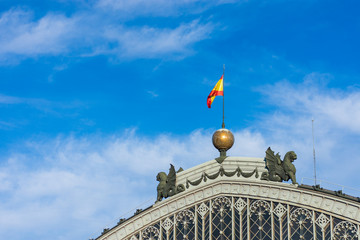 Spain flag on the facade of the railway station in the city of Madrid.
