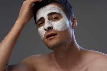 portrait of young man with facial mask on her face