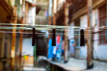 Clothespins on a wire in the courtyard. Selective focus and shallow depth of field.