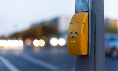 Traffic light switch for pedestrian crossing and blurred car lights in Berlin
