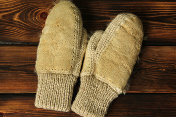 Mittens on a wooden background. Winter clothes