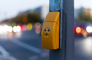 Traffic light switch for pedestrian crossing and blurred car lights in Berlin