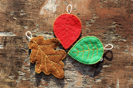 Colored leaves on a wooden background. Handmade leaves