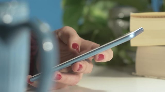 Extreme close up of a left-handed female browsing a smartphone