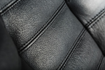 The texture of the black leather chairs. The seams close up.