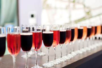 colourful cocktails in wine glasses in a classic bar setting