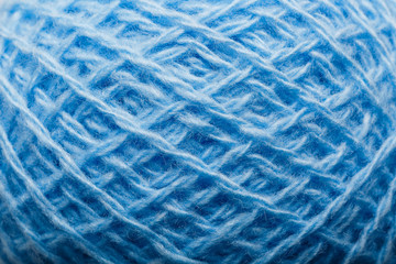 Wool yarn close-up colorful blue threads for needlework in macro.