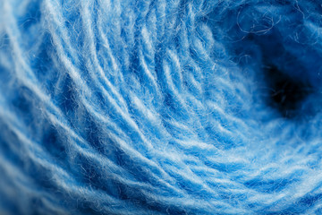 Wool yarn close-up colorful blue threads for needlework in macro.