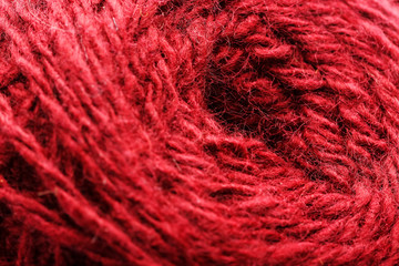 Wool yarn close-up colorful red thread for needlework in macro.