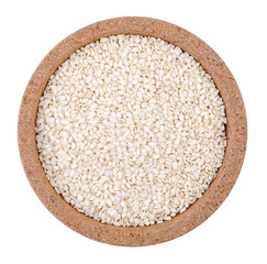 Sesame seeds on a plate on a white background