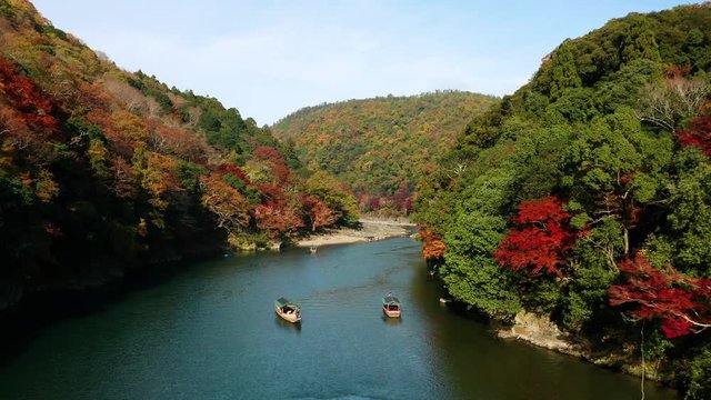 Aerial view of Katsura river at autumn and boats. Arashiyama, Kyoto, Japan