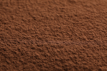 Cocoa powder textured background, close up and space for text