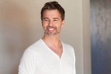 Portrait of a mature man smiling. Looking away. Really happy