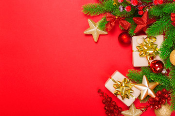 Christmas red background with herringbone and decor. Gold and red jewelry. Top view with space for copy.