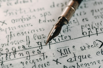 Fountain pen on an ancient handwritten letter. Old story. Retro style.