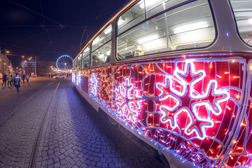 Christmas special tram illuminated by light with Christmas motif in Brno on traditional Moravian markets. - obrazy, fototapety, plakaty