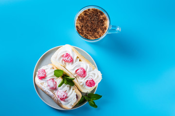 Air cake with raspberries on a saucer. Kefir with cinnamon, fermented drink.