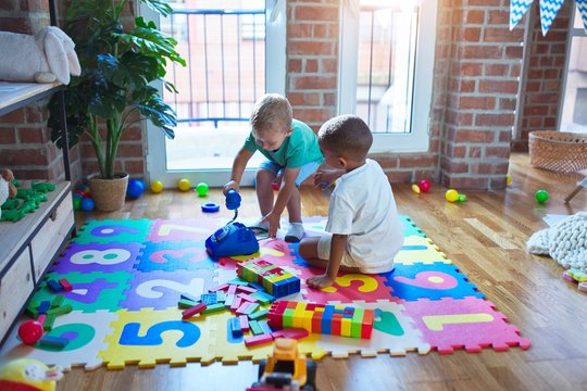 Adorable toddlers playing around lots of toys at kindergarten - Powered by Adobe