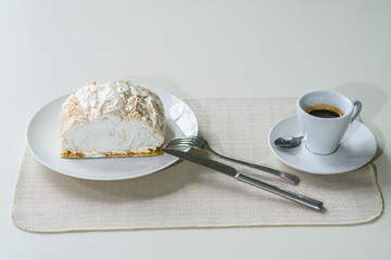 A delicious roll of bezrukov and a cup of coffee on a table in a cozy coffee shop