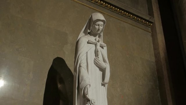 Woman saint statue catholic Therese of Lisieux by Beni Ferenczy crucifix in hands St. Stephen's Basilica in Budapest Hungary gimbal smooth camera movement
