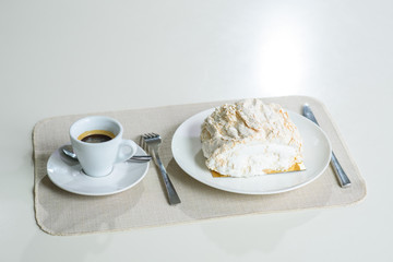 A delicious roll of bezrukov and a cup of coffee on a table in a cozy coffee shop