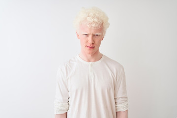 Young albino blond man wearing casual t-shirt standing over isolated white background skeptic and nervous, frowning upset because of problem. Negative person.