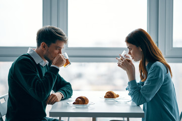 young couple having breakfast in cafe