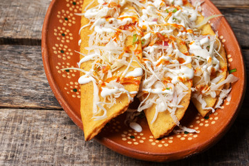 Yucatecan  empanadas on wooden background
