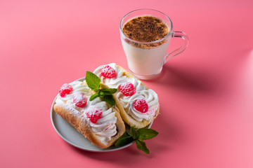Air cake with raspberries on a saucer. Kefir with cinnamon, fermented drink. Pink background