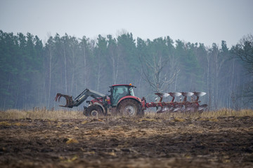 tractor plowing the field in autumn