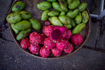 Platter of dragonfruit and green mangoes