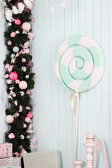 Colorful neo mint lollipop candy on pale background.