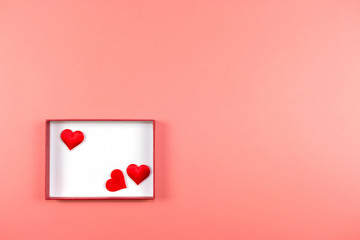 Love and Valentine's day concept., Decoration of red hearts in white box on pink or pastel background with copy space for text.